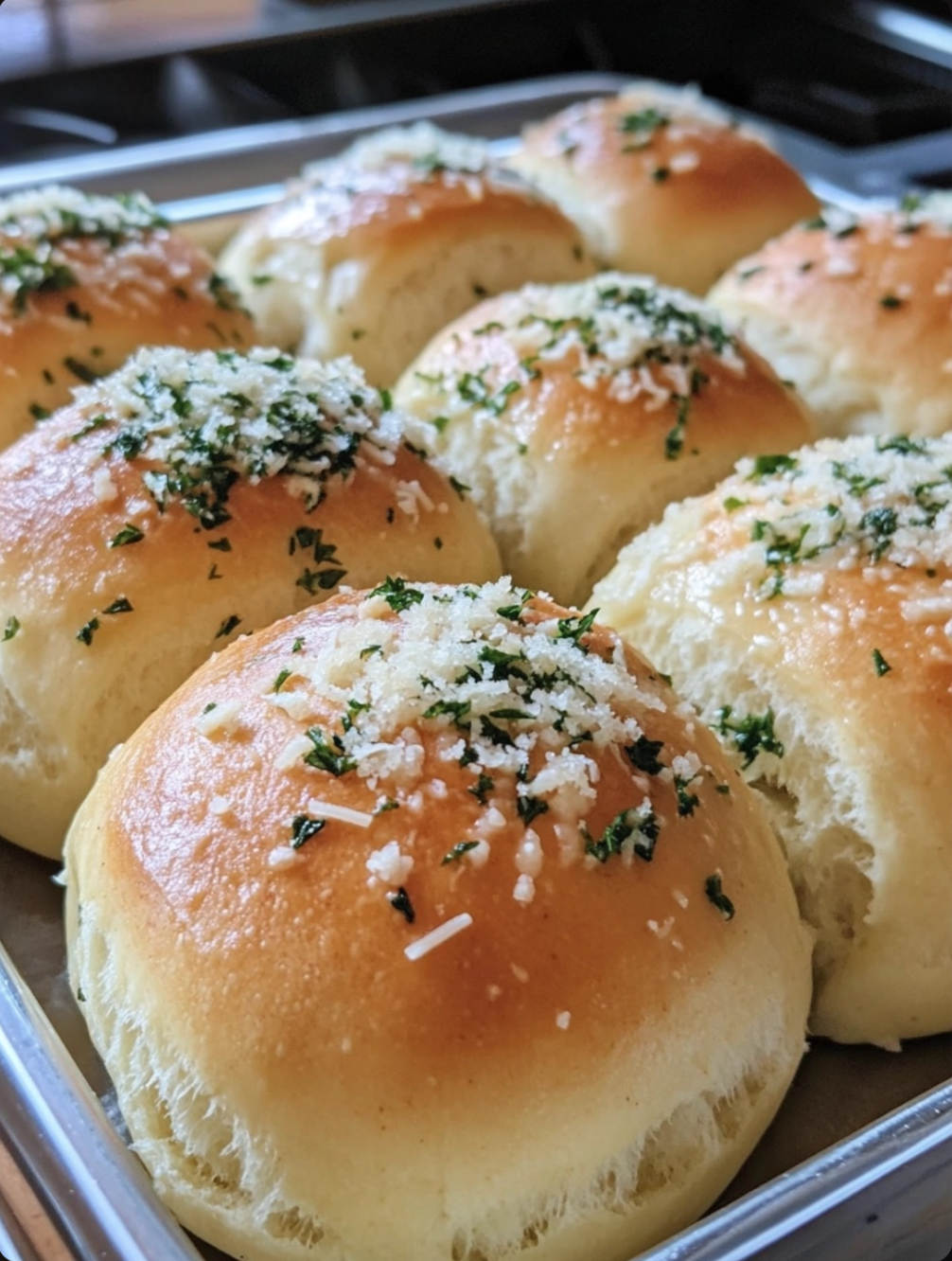 Soft Dinner Rolls Topped with Garlic and Herb Butter and Grated Parmesan