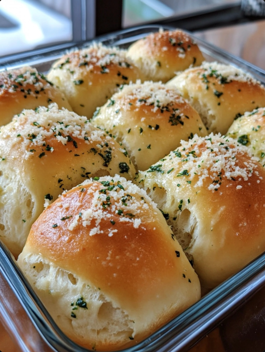 Soft Dinner Rolls Topped with Garlic and Herb Butter and Grated Parmesan